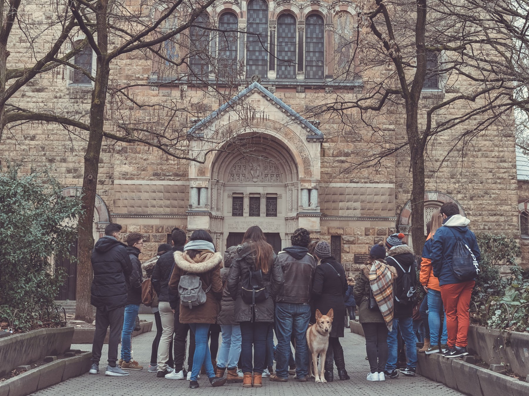 a group of people standing in front of a building