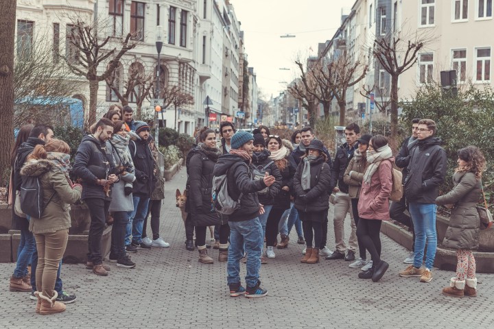 a group of people standing on a sidewalk