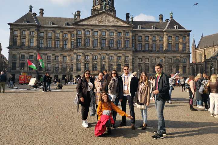 a group of people standing in front of a building