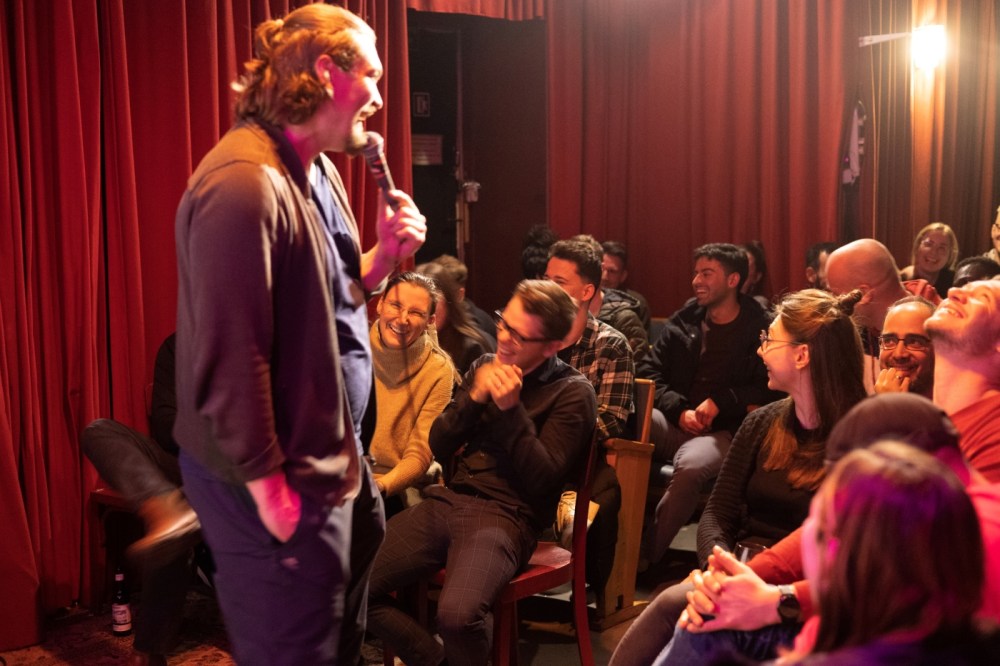 Comedian in front of the crowd at the Culture Shock Comedy show in Berlin