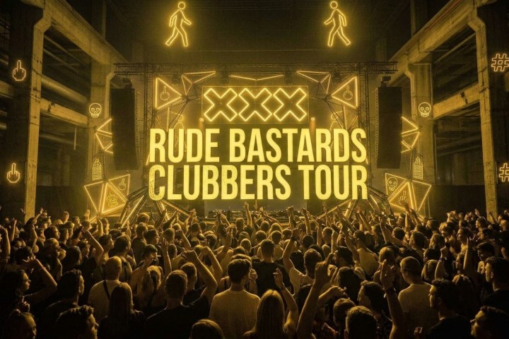 Crowd at a concert with 'Rude Bastards Clubbers Tour' on stage.